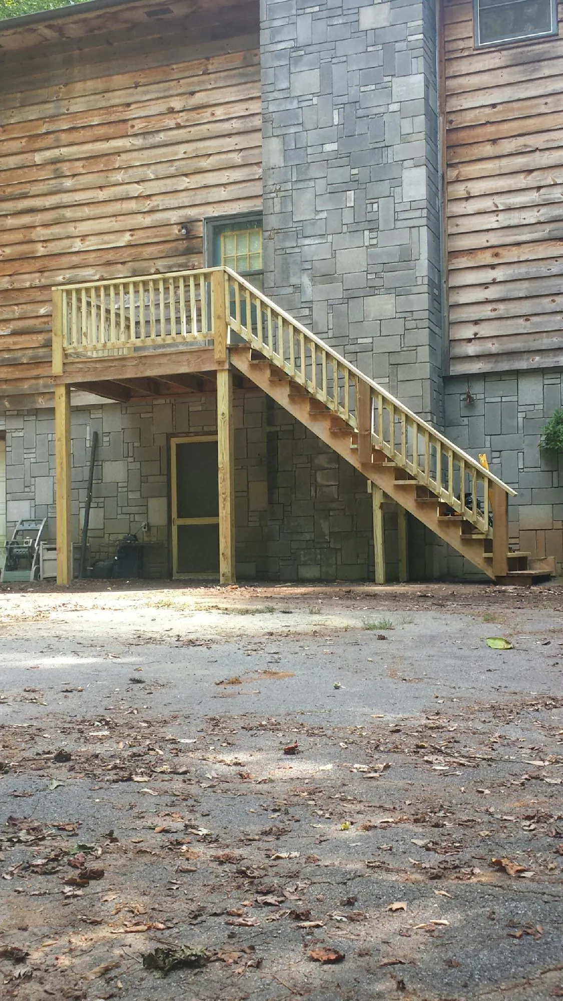New pressure treated deck and stair landing on a log home in Mount Holly Springs
